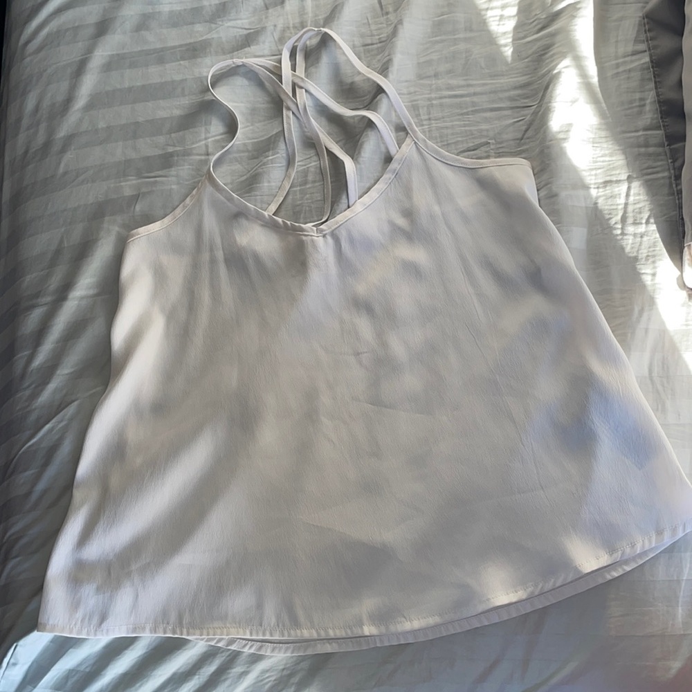 All white blouse with crossed straps.
